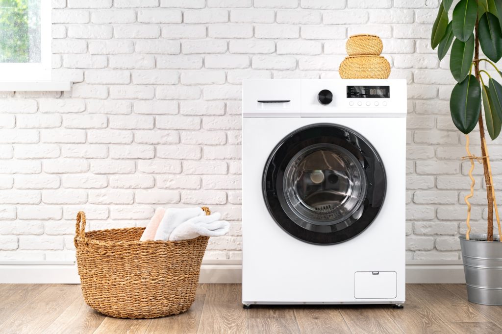 Washing machine and basket in a laundry room